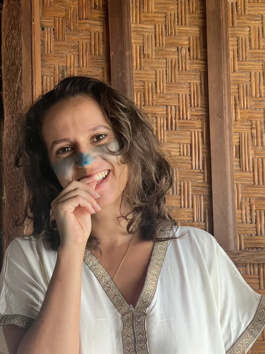 Inès with paint on her face, smiling